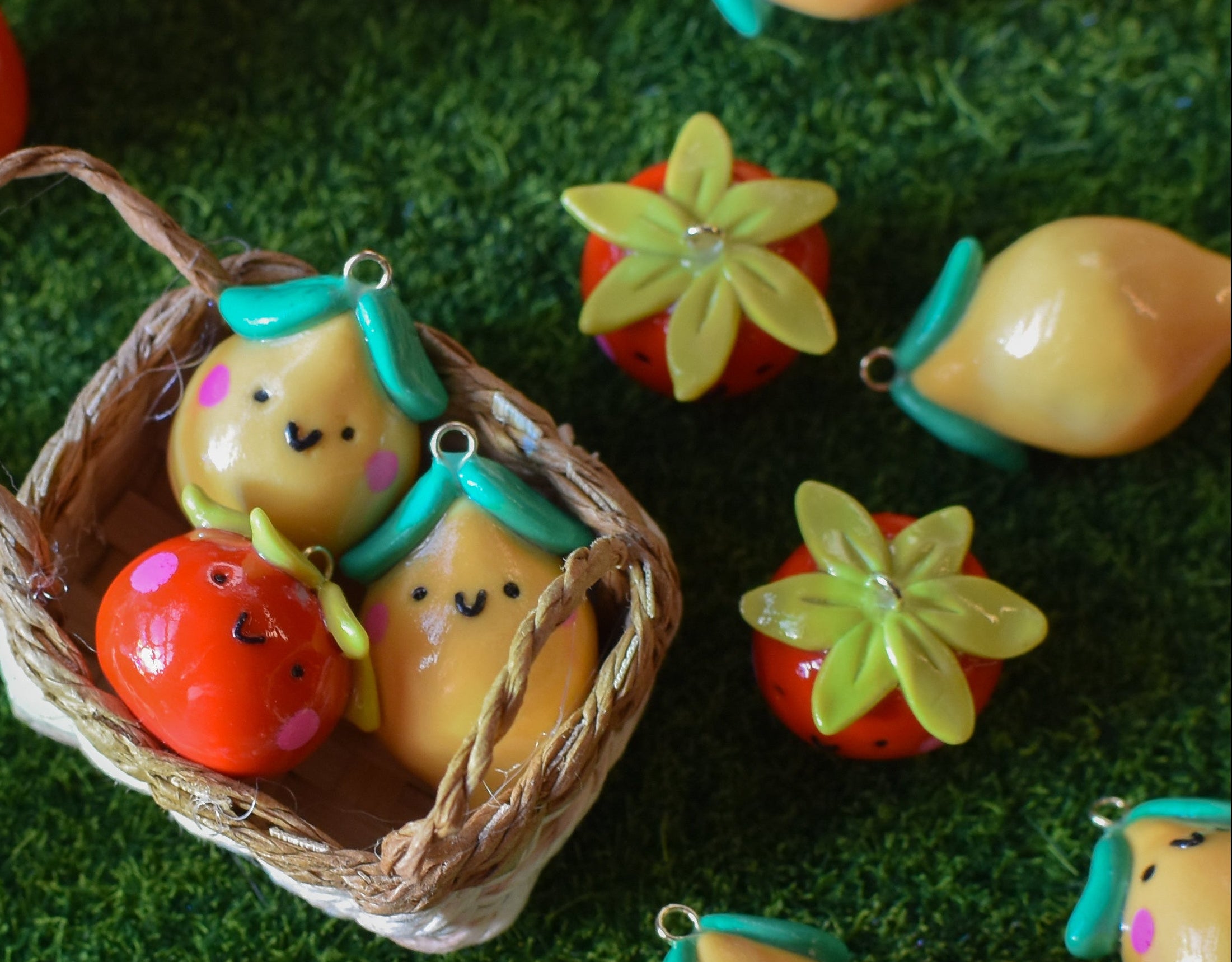Decorative items resembling fruits and vegetables in a basket on a green surface